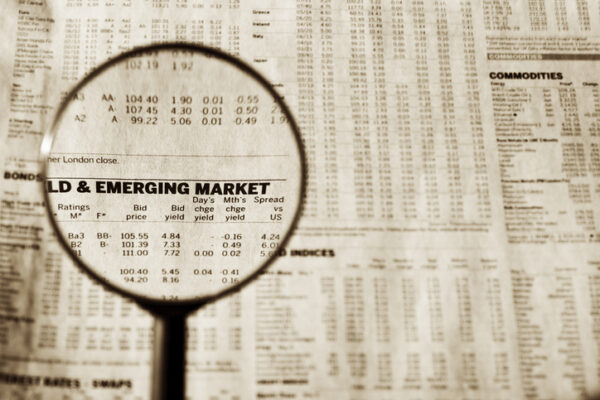 Loupe focusing on text on financial newspaper